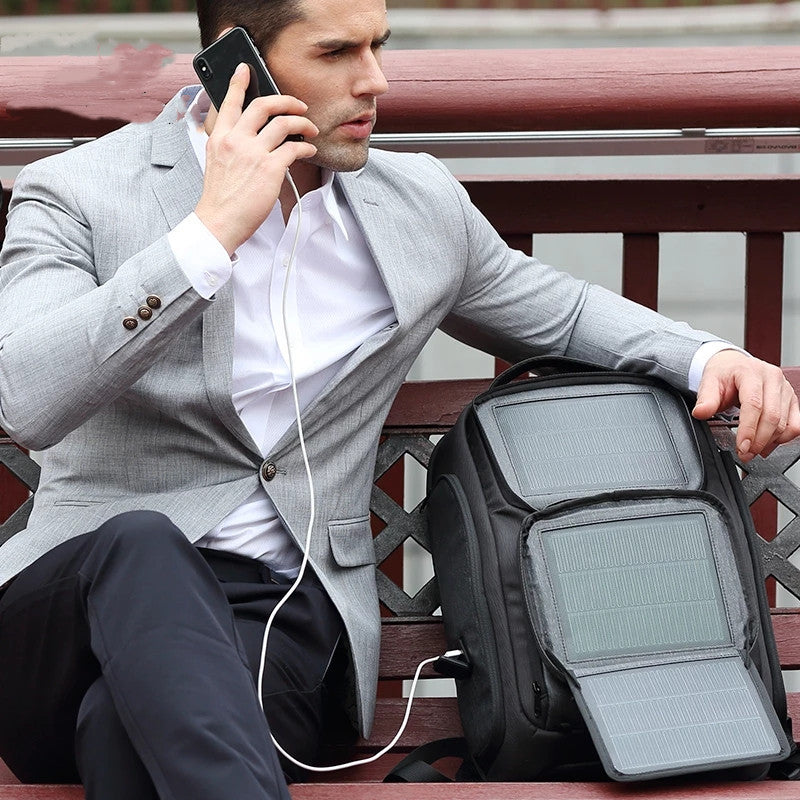 Stylish man using a Solar Charging Business Backpack with solar panels, perfect for work and travel.